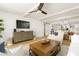 Bright living room with ceiling fan and wood floors adjacent to kitchen and dining areas at 5501 S Atlantic Ave # 4090, New Smyrna Beach, FL 32169