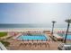 Beautiful oceanfront pool and sunbathing area with beach access, perfect for a relaxing vacation at 5501 S Atlantic Ave # 4090, New Smyrna Beach, FL 32169