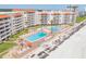 Aerial view of pools, spas, and beachside condos with orange umbrellas at 5501 S Atlantic Ave # 4090, New Smyrna Beach, FL 32169
