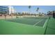 Well-maintained tennis court surrounded by lush greenery, providing an active lifestyle option at 5501 S Atlantic Ave # 4090, New Smyrna Beach, FL 32169