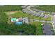 An aerial view of the community pool, playground, parking lot, and surrounding homes at 551 Armoyan Way, New Smyrna Beach, FL 32168