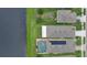 Aerial view of a backyard with a pool and solar panels, backing up to the lake at 551 Armoyan Way, New Smyrna Beach, FL 32168