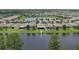 Aerial shot of homes in a lakeside community highlighting the peaceful, waterfront neighborhood at 551 Armoyan Way, New Smyrna Beach, FL 32168