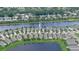 Waterfront homes feature well-manicured lawns and landscaping backing up to a large lake at 551 Armoyan Way, New Smyrna Beach, FL 32168