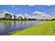 Scenic view of the calm lake and the lush green grass, perfect for relaxation at 551 Armoyan Way, New Smyrna Beach, FL 32168