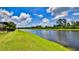 Beautiful backyard featuring lush green grass and serene lake views for relaxing outdoors at 551 Armoyan Way, New Smyrna Beach, FL 32168