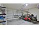 Spacious garage with ample storage space and a golf cart for convenience at 551 Armoyan Way, New Smyrna Beach, FL 32168