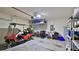 Garage featuring overhead storage, shelving, and a golf cart, providing functional space at 551 Armoyan Way, New Smyrna Beach, FL 32168
