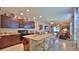 Well-equipped kitchen with barstool seating opening to the living area at 551 Armoyan Way, New Smyrna Beach, FL 32168