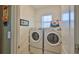 Well-organized laundry room features stacked washer and dryer, enhancing space and efficiency at 551 Armoyan Way, New Smyrna Beach, FL 32168