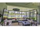 Enclosed patio with outdoor furniture and stunning lake views for relaxation and entertaining at 551 Armoyan Way, New Smyrna Beach, FL 32168