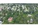 Aerial view of the land available near an existing single Gathering home and pool in a wooded area at 585 Corbin Park Rd, New Smyrna Beach, FL 32168