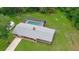 Aerial view of the property showing a screen-enclosed pool, and large backyard at 585 Corbin Park Rd, New Smyrna Beach, FL 32168