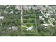 Aerial view of the property showing boundary lines, the home, the pool, and surrounding wooded area at 585 Corbin Park Rd, New Smyrna Beach, FL 32168