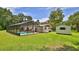 A backyard with a screened in private pool and an exterior shed at 585 Corbin Park Rd, New Smyrna Beach, FL 32168