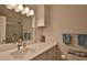 Well-lit bathroom with a spacious vanity, modern countertop, and framed mirror with lighting above at 585 Corbin Park Rd, New Smyrna Beach, FL 32168