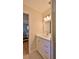 Bright bathroom featuring a white vanity, stylish lighting, and a glimpse into the bedroom at 585 Corbin Park Rd, New Smyrna Beach, FL 32168