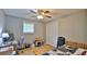 Functional bedroom featuring a ceiling fan, closet, window, desk, and a comfortable bed, perfect for relaxation and study at 585 Corbin Park Rd, New Smyrna Beach, FL 32168