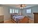 Comfortable bedroom with a ceiling fan, shuttered windows, and a plush bed offering a relaxing retreat within the home at 585 Corbin Park Rd, New Smyrna Beach, FL 32168