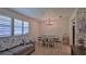 Bright dining area featuring wood floors, a chandelier, and large windows for ample natural light at 585 Corbin Park Rd, New Smyrna Beach, FL 32168