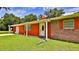 Well-maintained single-story home with a lush green lawn, covered entry, and a blend of siding and brick accents at 585 Corbin Park Rd, New Smyrna Beach, FL 32168