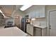 Updated kitchen with white cabinets, stainless steel appliances, and quartz countertops at 585 Corbin Park Rd, New Smyrna Beach, FL 32168