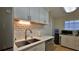 Bright kitchen featuring white cabinets, stainless steel appliances, and quartz countertops at 585 Corbin Park Rd, New Smyrna Beach, FL 32168