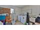 Functional laundry room with washer, dryer, and ample storage space at 585 Corbin Park Rd, New Smyrna Beach, FL 32168
