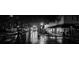 Atmospheric nighttime street scene featuring a reflective wet road and illuminated buildings at 585 Corbin Park Rd, New Smyrna Beach, FL 32168
