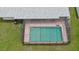 Aerial of a screened-in pool with a clean blue water, ladder and patio area at 585 Corbin Park Rd, New Smyrna Beach, FL 32168