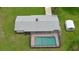 Aerial view of a screened-in pool surrounded by lush green grass, with a small storage shed nearby at 585 Corbin Park Rd, New Smyrna Beach, FL 32168