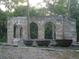 Historic ruins featuring stone arches and large iron pots, evoking a sense of the past at 585 Corbin Park Rd, New Smyrna Beach, FL 32168