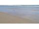 Gentle waves lapping on the sandy shoreline creates a serene beach view at 585 Corbin Park Rd, New Smyrna Beach, FL 32168