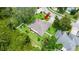 Aerial view of the home highlighting the roof, landscaping, fenced yard, and proximity to neighboring properties at 5935 Shady Creek Ln, Port Orange, FL 32128