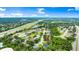 Aerial view of the property showcasing its location near a highway, lake, and other residential homes at 5935 Shady Creek Ln, Port Orange, FL 32128