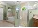 The bathroom features a walk-in shower, a bathtub, tile floors, and accessible grab bars at 5935 Shady Creek Ln, Port Orange, FL 32128