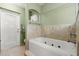 The bathroom features a bathtub with jets, tile floors, and a door to the water closet at 5935 Shady Creek Ln, Port Orange, FL 32128
