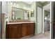 Bathroom with a double sink vanity, granite countertops, and wooden cabinets at 5935 Shady Creek Ln, Port Orange, FL 32128