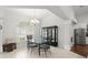 Dining room with a glass table, chandelier, and natural light from the arched window at 5935 Shady Creek Ln, Port Orange, FL 32128