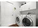 The laundry room features a washer, dryer, cabinets, and tile floor at 5935 Shady Creek Ln, Port Orange, FL 32128