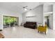 Bright open-concept living room with tile flooring, ceiling fan, and sliding doors to the lanai at 5935 Shady Creek Ln, Port Orange, FL 32128