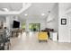 Bright open-concept living room with tile flooring, ceiling fan, and sliding doors to the lanai at 5935 Shady Creek Ln, Port Orange, FL 32128