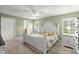 Bright main bedroom with a white bed frame, neutral carpet, and a ceiling fan at 5935 Shady Creek Ln, Port Orange, FL 32128