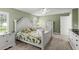 Bright main bedroom with a white bed frame, neutral carpet, and shutters on the windows at 5935 Shady Creek Ln, Port Orange, FL 32128