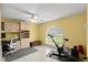 A flexible office space with built-in shelving, natural light, and exercise equipment at 5935 Shady Creek Ln, Port Orange, FL 32128