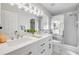 Bright bathroom featuring double sink vanity, marble floors, and glass enclosed shower at 620 Middlebury Loop, New Smyrna Beach, FL 32168
