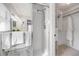Bright bathroom showing a glass enclosed shower, toilet, and vanity with mirrors at 620 Middlebury Loop, New Smyrna Beach, FL 32168