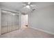 Bright bedroom with a ceiling fan and mirrored closet doors at 620 Middlebury Loop, New Smyrna Beach, FL 32168