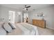 Bright bedroom featuring carpet, ceiling fan, wood dresser and ensuite bathroom at 620 Middlebury Loop, New Smyrna Beach, FL 32168