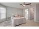 Neutral bedroom with carpet, ceiling fan, side tables and access to an ensuite bathroom at 620 Middlebury Loop, New Smyrna Beach, FL 32168